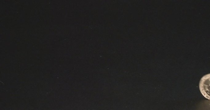 Gold Bitcoin Token Rolls across a black background