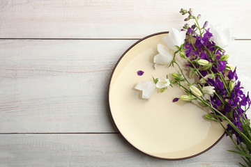 Obraz na płótnie Canvas flowers bell and a plate