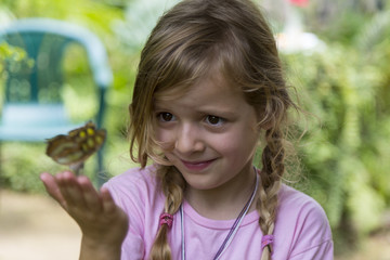 Smirking Blond Girl With Yellow Spotted Butterfly