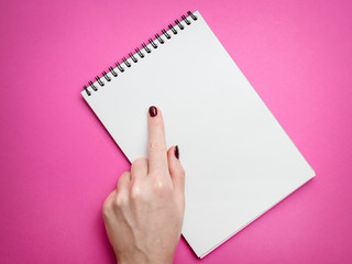 Design concept - Top view of man's hand holding hardcover gray linen notebook and ballpoint pen isolated on white background for mockup