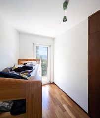 Fototapeta na wymiar Bedroom with bunk bed and window overlooking the lake