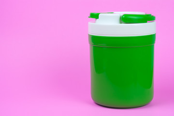 Green Bottle for Cold Water on pink Background.