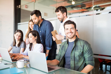 Man with coworkers working in conference room
