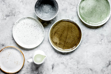 ceramic tableware top view on stone background mock up