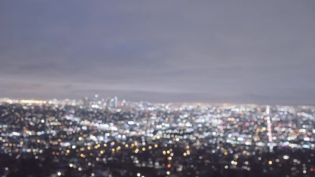 Night overview of Los Angeles from Griffith Observatory - defocusing lens, wide shot