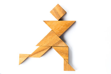 Wood tangram puzzle in man running shape on white background