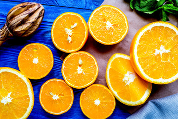 orange juice with mint squeezing on blue kitchen background top 