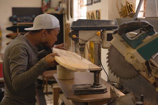 Man using radial drill machine in workshop