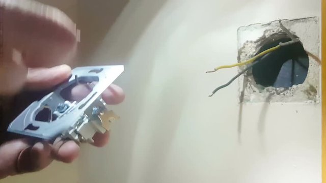 Change of a socket at a house by a man.
