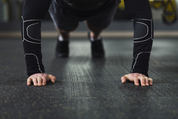 Naklejka premium Young man fitness workout, push ups or plank