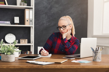 Business woman taking notes at workplace