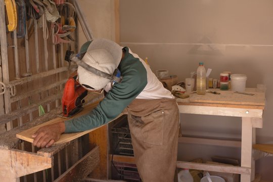 Man making skateboard in workshop