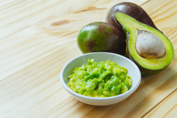 Avocado on the wooden to make healthy food or cooking concept.