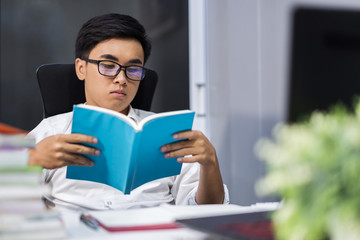 young student reading book