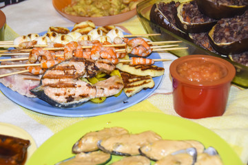 Greek meze a lot of food sauces skewers seafood shrimp fish mussels eggplant meat
