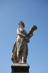 Fototapeta premium Firenze, Italy - June 21, 2018 : Statue of Summer by Giovanni Caccini at Ponte Santa Trinita (Holy Trinity Bridge), the oldest elliptic arch bridge in the world.