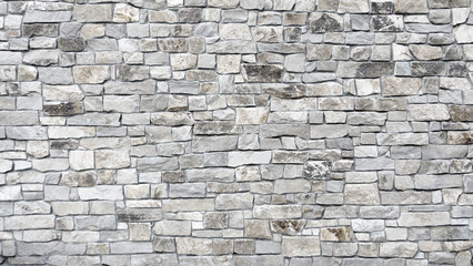 light grey stone brick like wall with cement joints