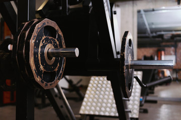 Disassembled barbell on floor in gym.Sports equipment. diverse equipment and machines at the gym room