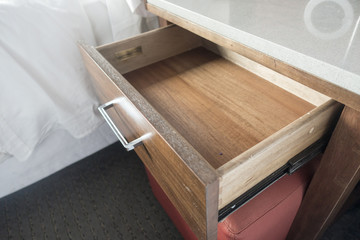 close up of open bedside wooden drawer - obrazy, fototapety, plakaty