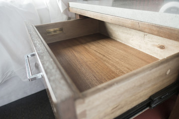 close up of open bedside wooden drawer