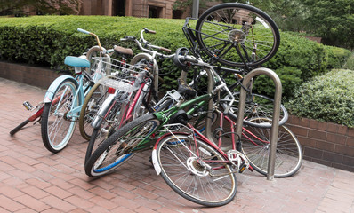 Fototapeta na wymiar jumbled up, messy, bicycles, parked, locked, bike rack
