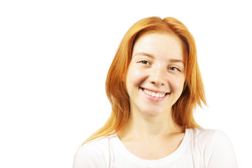 Beautiful redheaded young woman with satisfied facial expression, isolated on white background. Attractive female with natural red hair & brown eyes showing sincere smile & perfect teeth. Copy space.