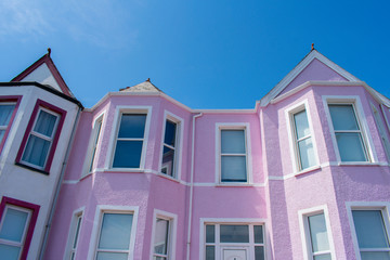 Fototapeta premium colorful pink house against blue sky in whitehead northern ireland