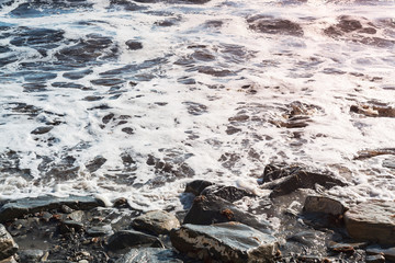 rocky coast of the sea with bubbling water