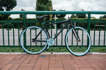 Fototapeta na wymiar abundant bicycle parked and locked on fence by street