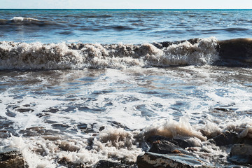 rocky coast of the sea with bubbling water