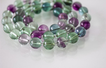 close up macro natural fluorite gem beads isolated on white background