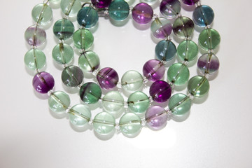 close up macro natural fluorite gem beads isolated on white background