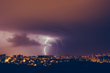 Thunderstorms vivid blue sky and lightnings above night city