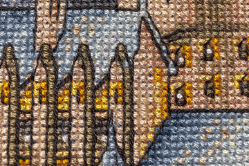 Cross-stitch. Macro photography of embroidery sites. Shooting with a small bluff of sharpness.