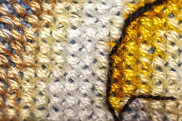 Cross-stitch. Macro photography of embroidery sites. Shooting with a small bluff of sharpness.