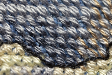 Cross-stitch. Macro photography of embroidery sites. Shooting with a small bluff of sharpness.