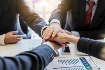 Business people together to work as a team to ensure the success of the business. Teamwork...