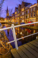 Evening view of the canal and the church in Delft. Dutch city in the spring after sunset. Holland, Netherlands.