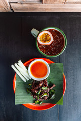 Neur Dad Diew (Thai Fried Sun-Dried Beef) with chili sauce served on zinc plate with iced passion fruit juice.