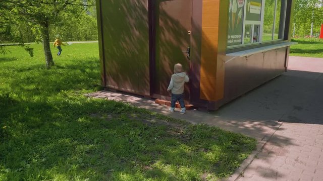 Mom and son play hide and seek in park