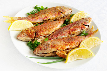 fried breaded goatfishes with lemon