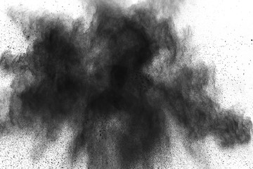 Black powder explosion. Closeup of black dust particles splash isolated on  background.