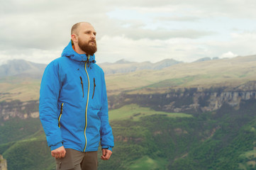 Rugged bearded man in in a membrane jacket headshot country masculine midwest mountain male