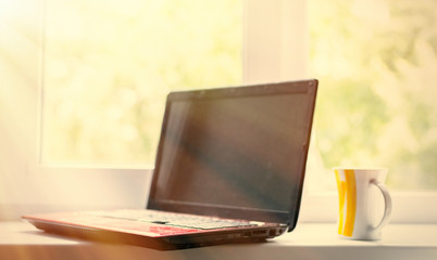 Fototapeta premium Coffee and laptop. The concept of freelancing, preparation for work, a break. Toned.