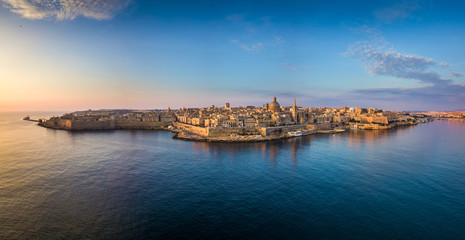 Valletta, Malta - Aerial panoramic skyline of Valletta at sunrise with Our Lady of Mount Carmel...