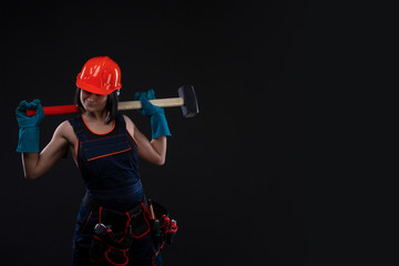 Sex equality and feminism. Sexy girl in safety helmet holding hammer tool. Attractive woman working...