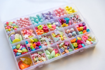 Many Different Beads and Jewelry Isolated on White Background