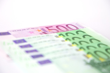 Euro banknotes close up. Several hundred euro banknotes on white background