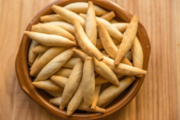 bread sticks in a brown bowl