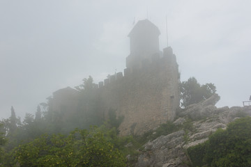 Castle on Monte Titano in San Marino in the fog 